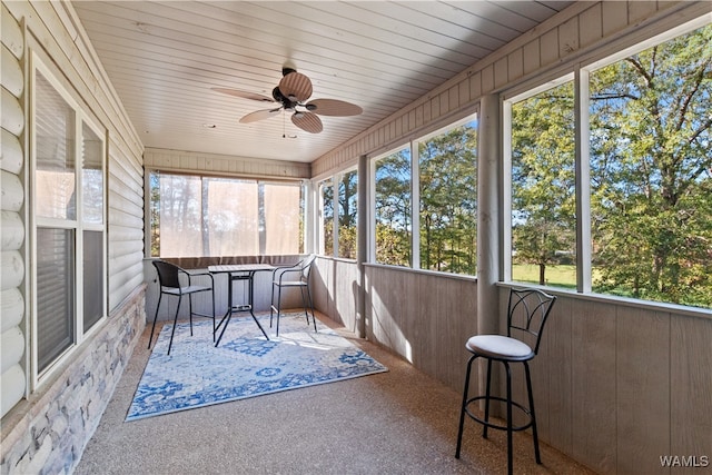 sunroom / solarium featuring ceiling fan