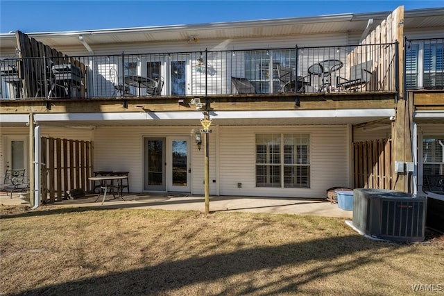 rear view of house featuring a balcony, a patio, and central AC