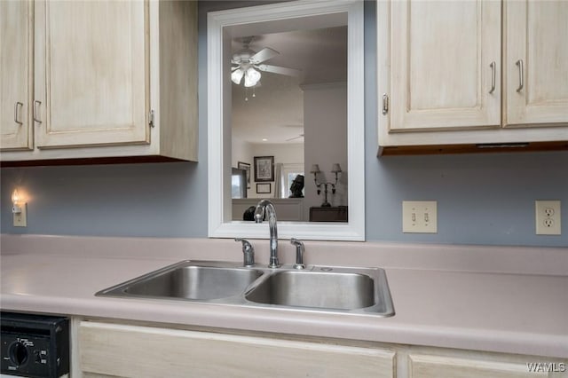 kitchen with light brown cabinets, a sink, light countertops, dishwasher, and ceiling fan