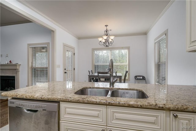 kitchen featuring sink, stainless steel dishwasher, hanging light fixtures, and light stone countertops