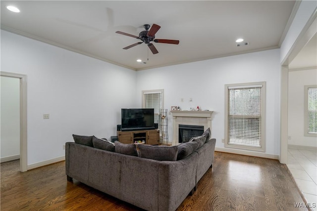 living room featuring ceiling fan, ornamental molding, and dark hardwood / wood-style floors