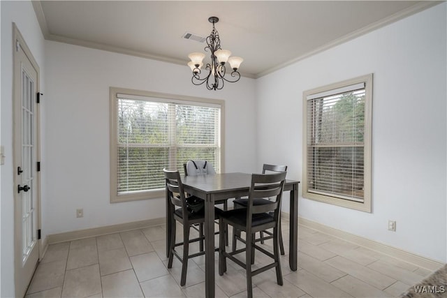 dining area featuring crown molding and a notable chandelier