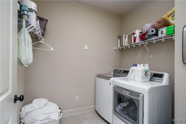 laundry area featuring light tile patterned floors and independent washer and dryer