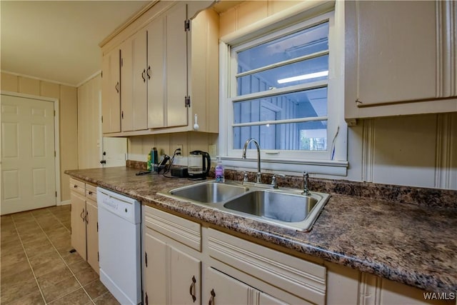 kitchen with dishwasher, sink, light tile patterned floors, and white cabinets