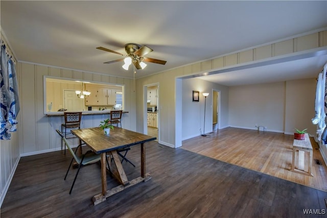 dining room featuring ornamental molding, dark hardwood / wood-style floors, and ceiling fan with notable chandelier