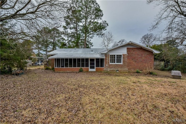 back of property with a sunroom