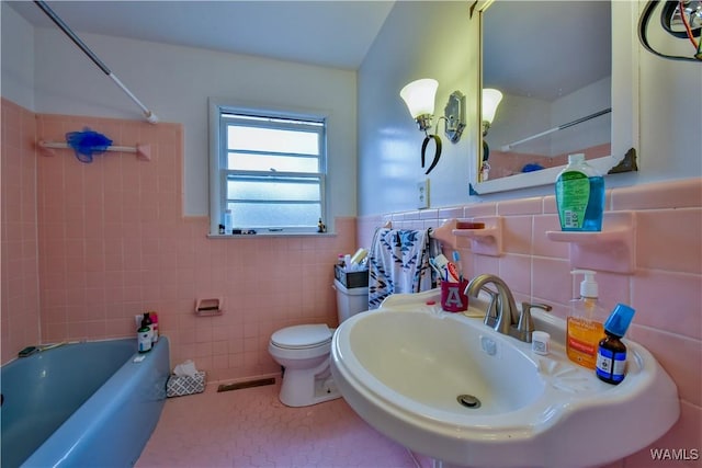 full bathroom featuring  shower combination, toilet, sink, and tile walls