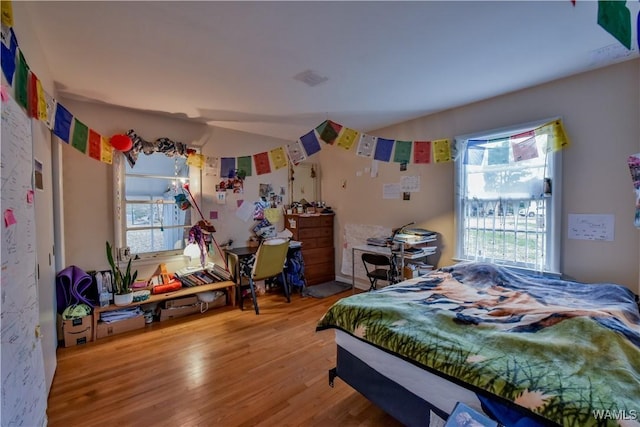 bedroom with hardwood / wood-style flooring