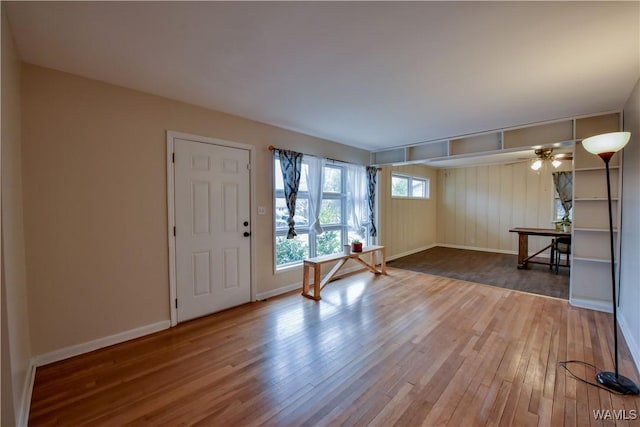 foyer entrance with hardwood / wood-style floors and ceiling fan