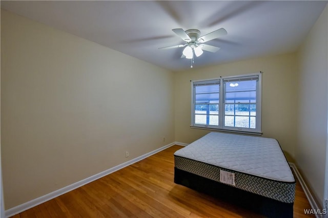 bedroom featuring wood-type flooring and ceiling fan