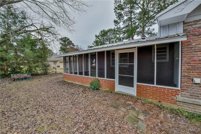 rear view of property with a sunroom