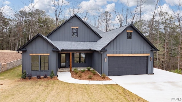 modern farmhouse featuring a front yard and a garage