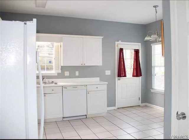 kitchen with light tile patterned flooring, white cabinets, decorative light fixtures, and white appliances