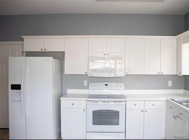 kitchen featuring white cabinets and white appliances