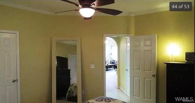 bedroom featuring ceiling fan and ornamental molding