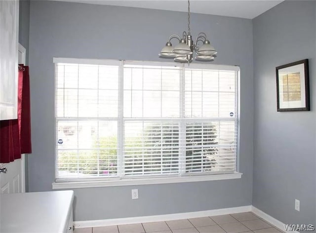 unfurnished dining area featuring light tile patterned floors and an inviting chandelier