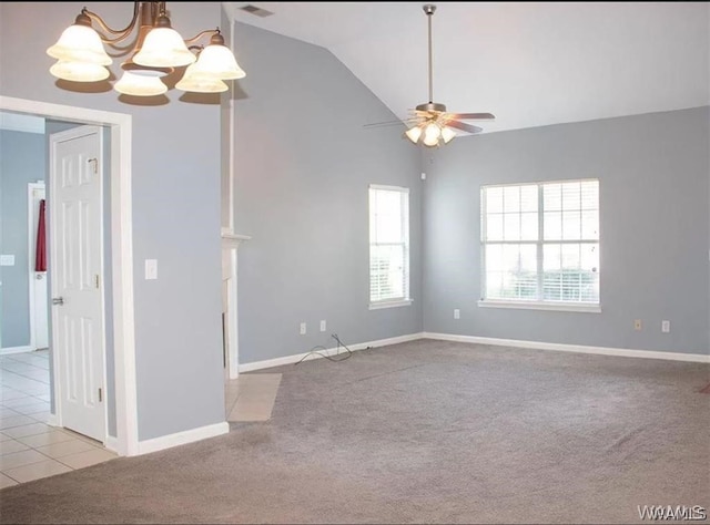 carpeted empty room with ceiling fan with notable chandelier and lofted ceiling