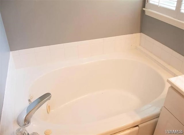 room details featuring a bathing tub and vanity