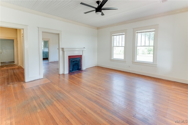 unfurnished living room with a fireplace, ceiling fan, light hardwood / wood-style flooring, and ornamental molding