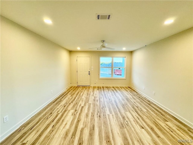 unfurnished room with visible vents, recessed lighting, baseboards, and light wood-style floors