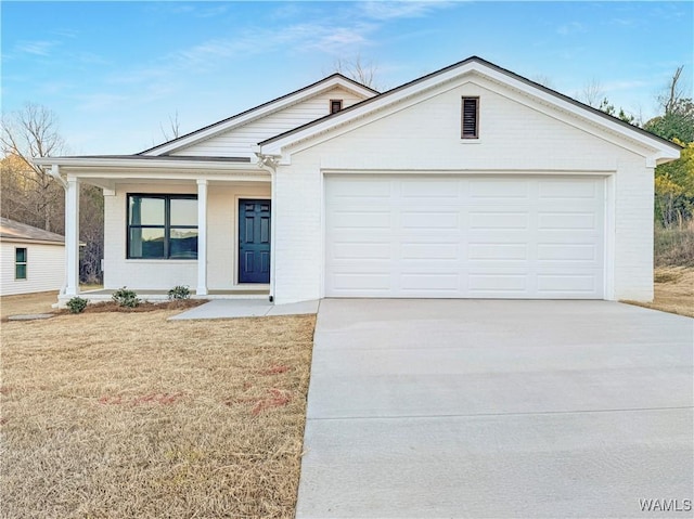 ranch-style home with a front yard, an attached garage, and driveway