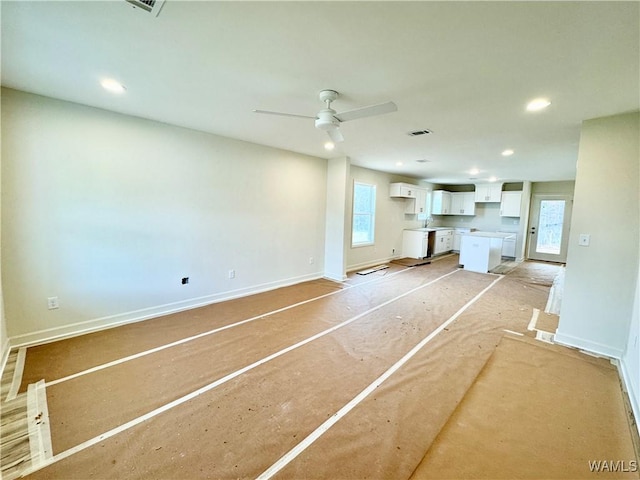 unfurnished living room with a ceiling fan, recessed lighting, visible vents, and baseboards