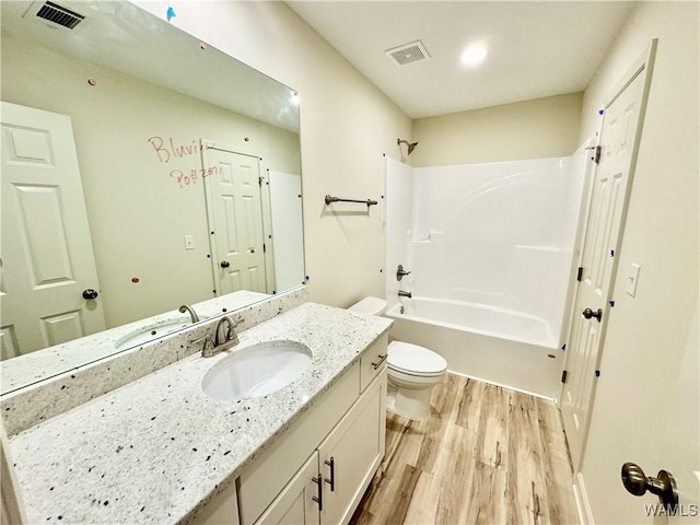 full bath featuring visible vents, toilet, vanity, and wood finished floors