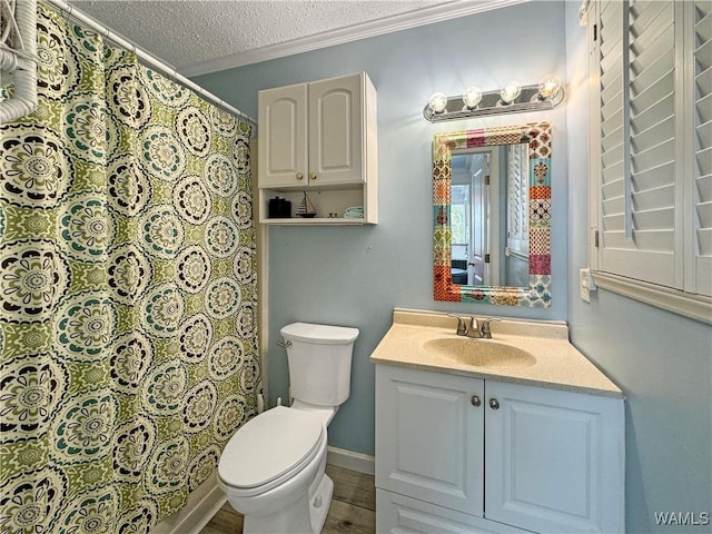 bathroom featuring vanity, wood finished floors, ornamental molding, a textured ceiling, and toilet