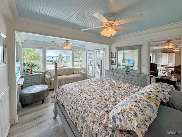 bedroom with light wood finished floors, radiator heating unit, a sunroom, ceiling fan, and crown molding