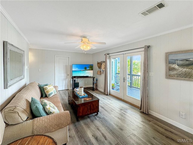 living room with visible vents, wood finished floors, french doors, and ornamental molding