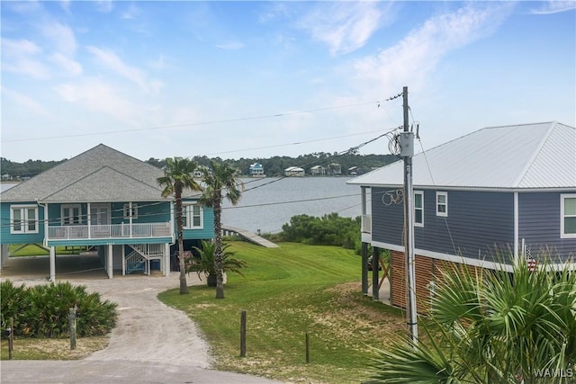 exterior space featuring a carport, a lawn, and driveway