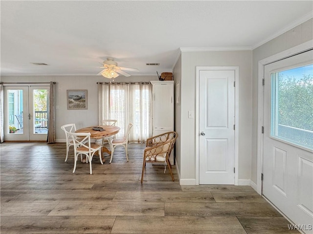 unfurnished dining area featuring crown molding, wood finished floors, and visible vents