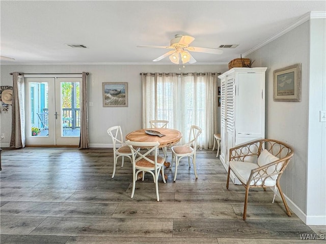 dining room with visible vents, baseboards, ornamental molding, french doors, and wood finished floors