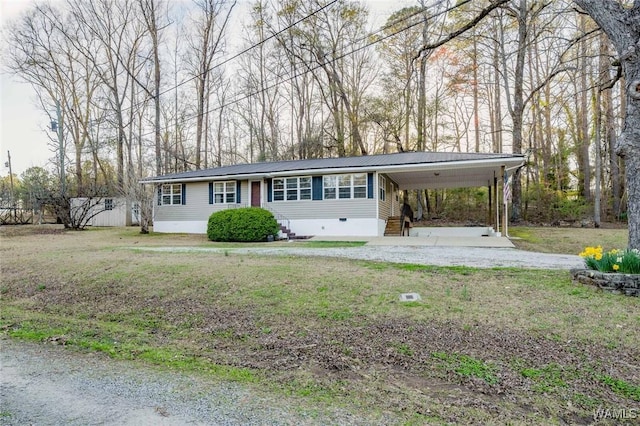 view of front facade with a carport, a front lawn, driveway, and crawl space