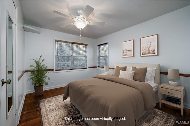 bedroom featuring ceiling fan, baseboards, and dark wood-style flooring