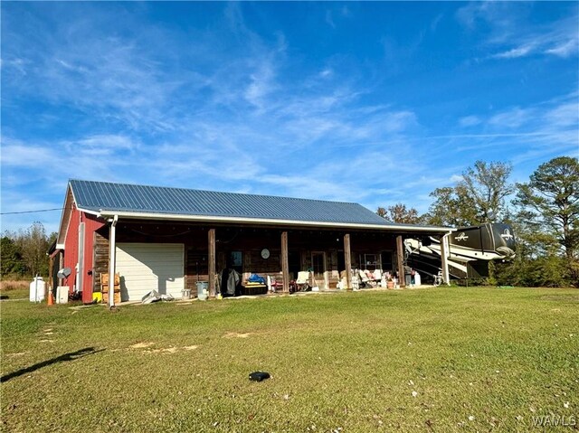 view of pole building with a lawn