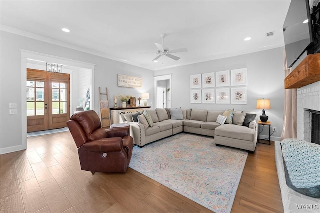 13880 Glenview Dr, Northport, AL 35475 - living room featuring crown molding, a ceiling fan, wood finished floors, recessed lighting, and a brick fireplace