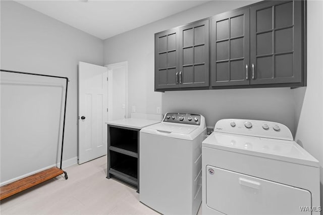 13880 Glenview Dr, Northport, AL 35475 - laundry area featuring cabinet space, washing machine and clothes dryer, and baseboards