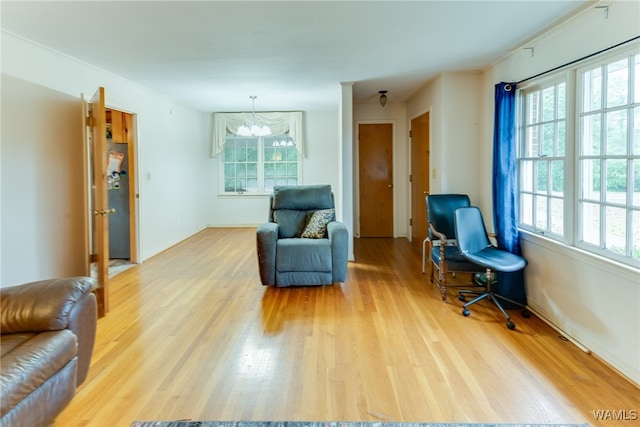 living area featuring hardwood / wood-style floors and an inviting chandelier