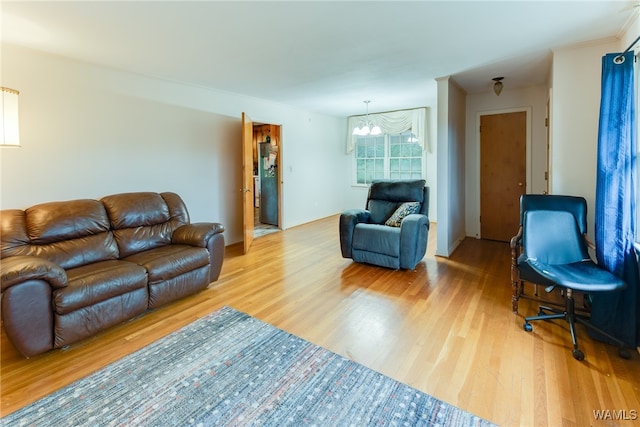 living room featuring wood-type flooring and an inviting chandelier