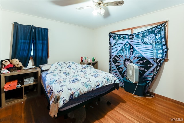 bedroom with wood-type flooring and ceiling fan