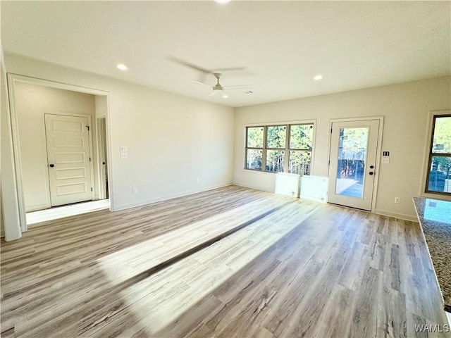 spare room with a ceiling fan, recessed lighting, light wood-style floors, and baseboards