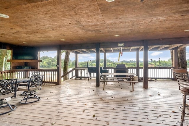 wooden terrace featuring a water view