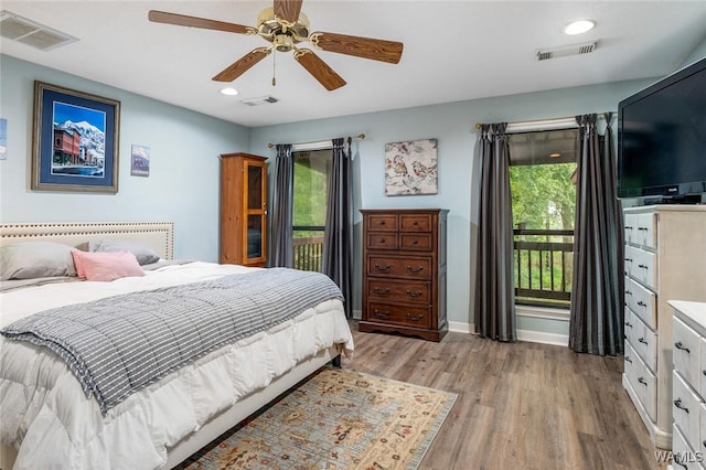 bedroom featuring ceiling fan, access to exterior, and light hardwood / wood-style floors