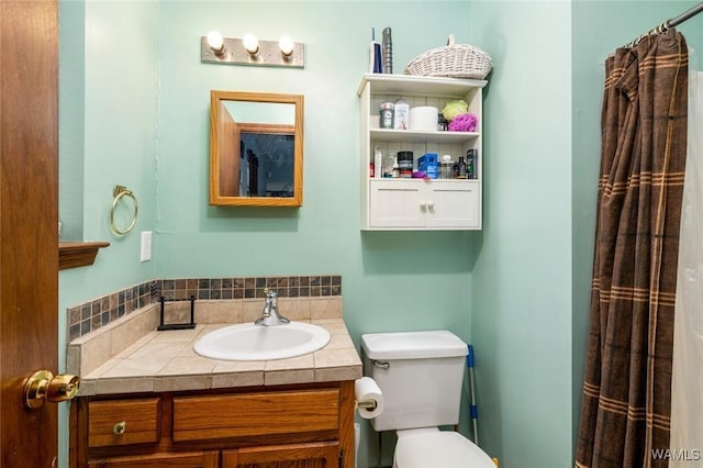 bathroom with vanity, curtained shower, and toilet