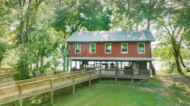 exterior space featuring a wooden deck and a front yard