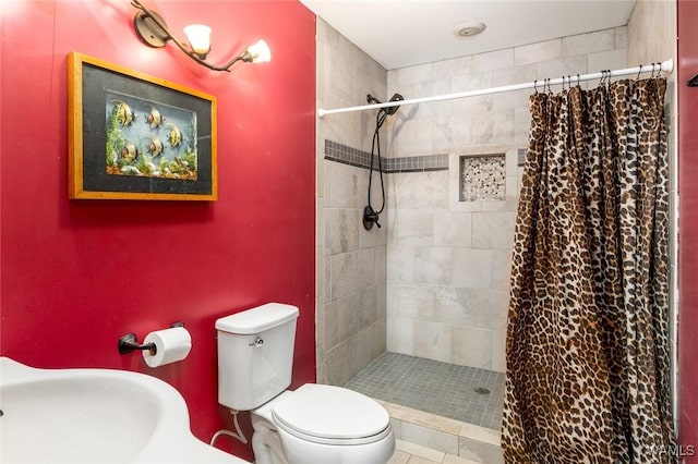 bathroom with sink, a shower with curtain, and toilet