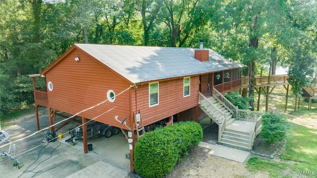 back of property with a carport