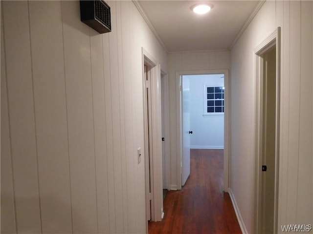 hall with dark hardwood / wood-style flooring and ornamental molding