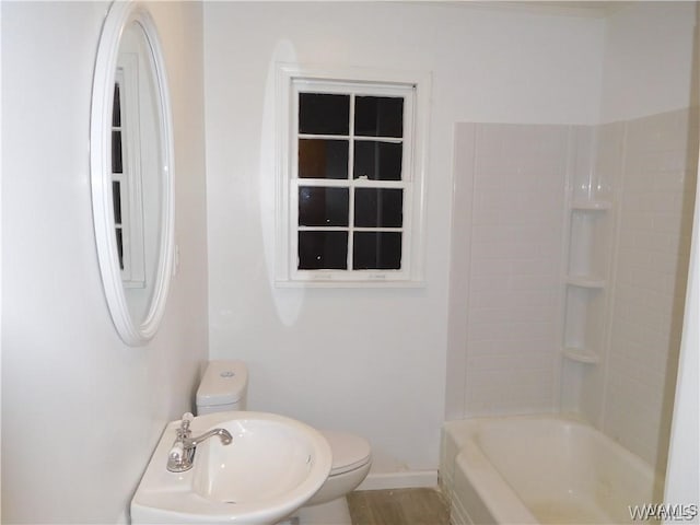 full bathroom featuring sink, shower / bathtub combination, and toilet